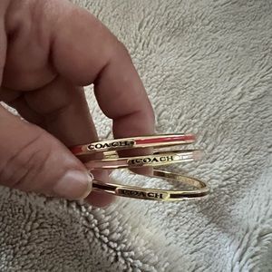Set of gold Coach bangles